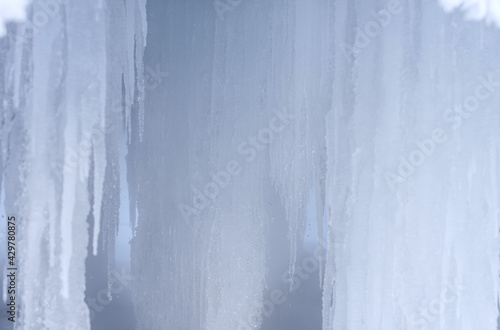 Ice caves. Formation of large icicles. Ice stalactites 