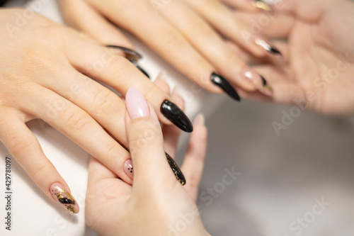 elegant female hands with long nails after procedure manicure in a beauty salon