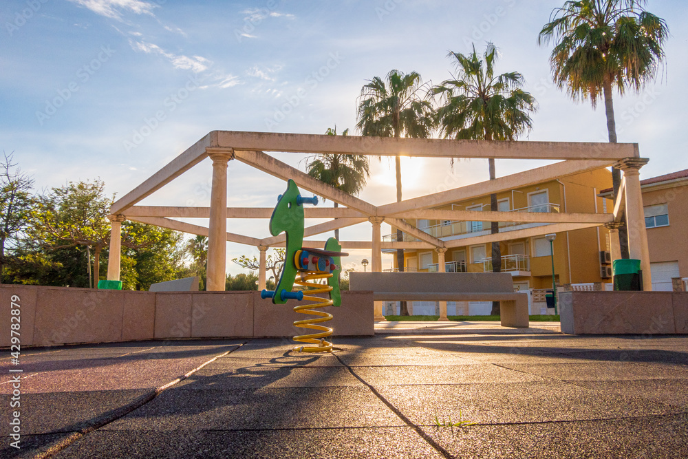 Decorative structure with stone pillars and benches in a playground. Decorative structure with stone pillars and benches in a playground.