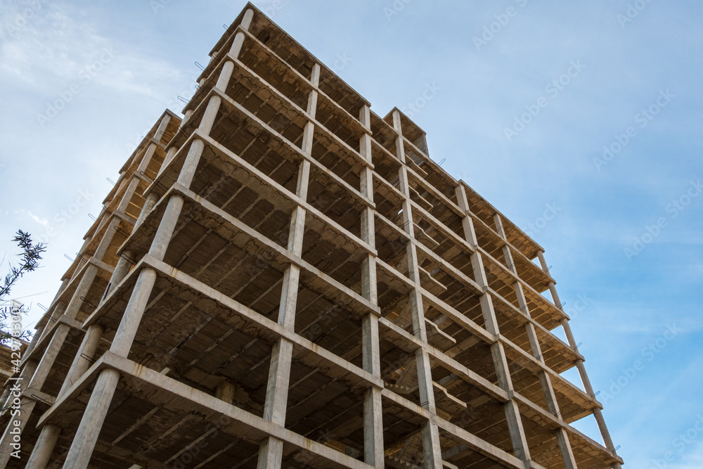 Structure of an abandoned building under construction, in a sunset with blue sky and a little cloudy. Structure of an abandoned building under construction, in a sunset with blue sky and a little cloudy.