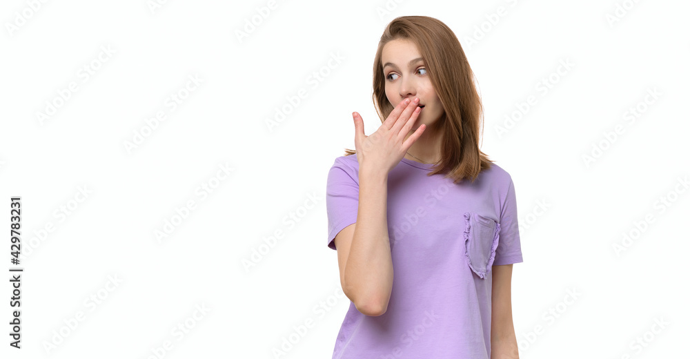 Young woman covering mouth with hand, looking serious, promises to keep secret. Place for your text Young woman covering mouth with hand, looking serious, promises to keep secret. Place for your text