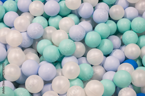 Abstract background from plastic balls of white  blue and green colors