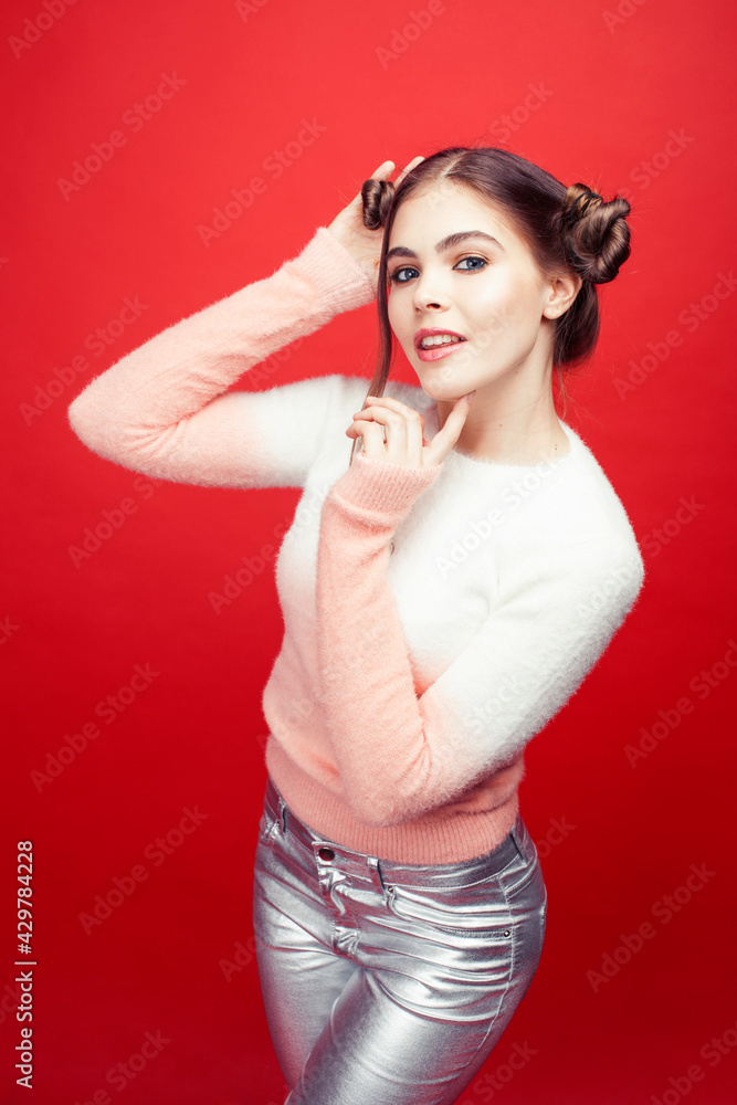 young pretty emitonal posing teenage girl on bright red background, happy smiling lifestyle people concept young pretty emitonal posing teenage girl on bright red background, happy smiling lifestyle people concept