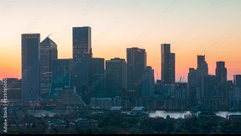 Sunrise time lapse view to the financial district Canary Wharf in London, United Kingdom, with the coporate and residential skyscrapers Sunrise time lapse view to the financial district Canary Wharf in London, United Kingdom, with the coporate and residential skyscrapers