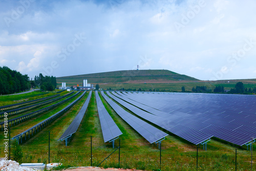 Farm with solar electric panels on a green field
