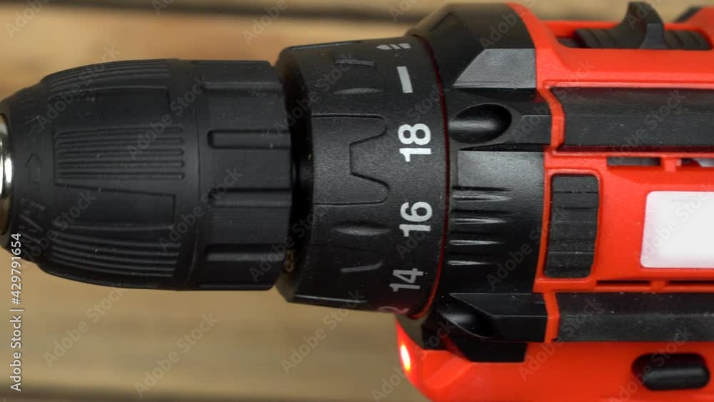 Cordless hand drill screwdriver with auger drill. The drill starts to rotate slowly. Close-up Cordless hand drill screwdriver with auger drill. The drill starts to rotate slowly. Close-up