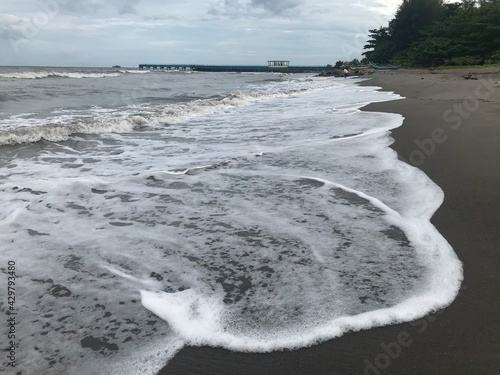 Ocean Seascape With Waves Crashing On Sandy Shore