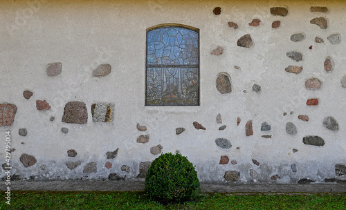 Close-up photos of the architectural details and the belfry of the Catholic church of Saint Józef Rzemielnik built in the 20th century in Nakomiady in Masuria, Poland.