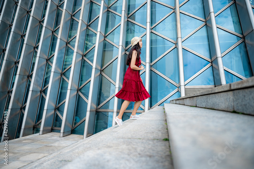 Asian woman in red dress at...