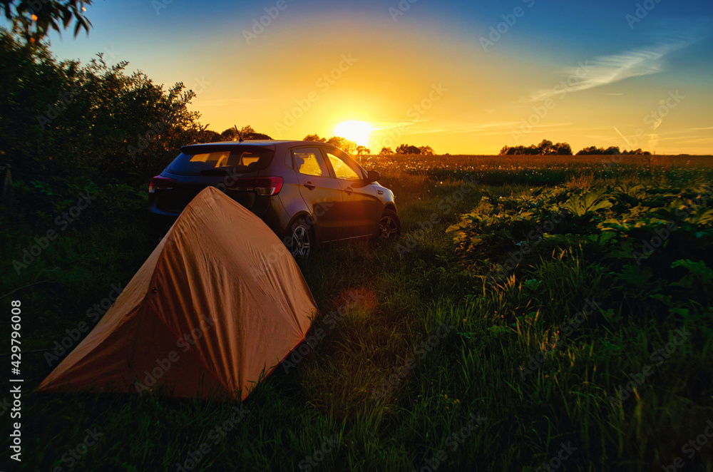 Camping tent, car and sunset - 
recipe for a great holiday.