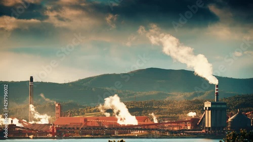 Industrial landscape on coast in Galicia Spain. Smoke from the factory chimney. Ecological pollution.