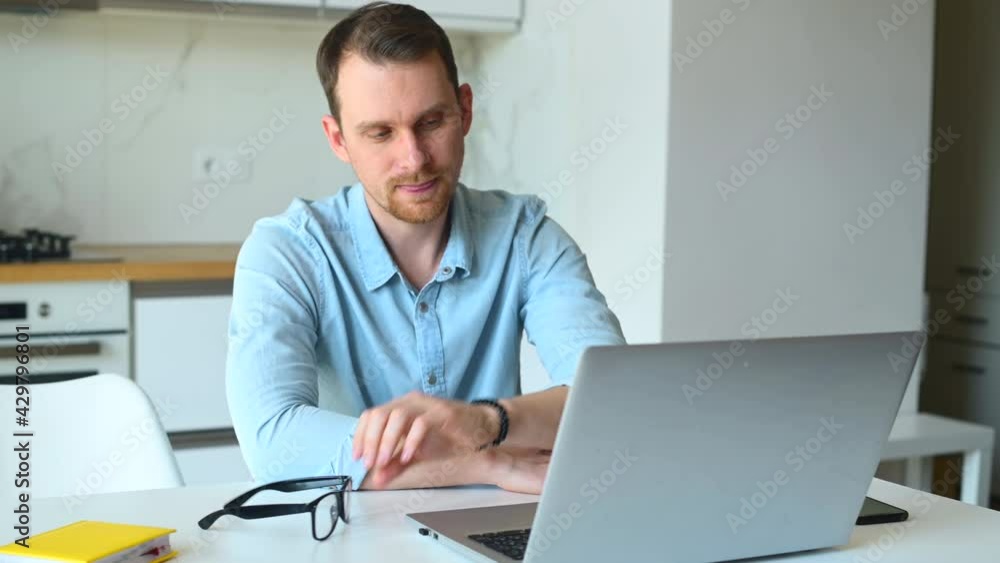 Tired young businessman has vision problem after long-time work with a laptop, taking his eyeglasses off and feels headache and eye strain, exhausted freelancer feels a lack of sleep, burnout Tired young businessman has vision problem after long-time work with a laptop, taking his eyeglasses off and feels headache and eye strain, exhausted freelancer feels a lack of sleep, burnout