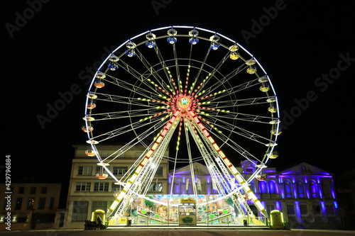 Colourful ferris wheel at night in France