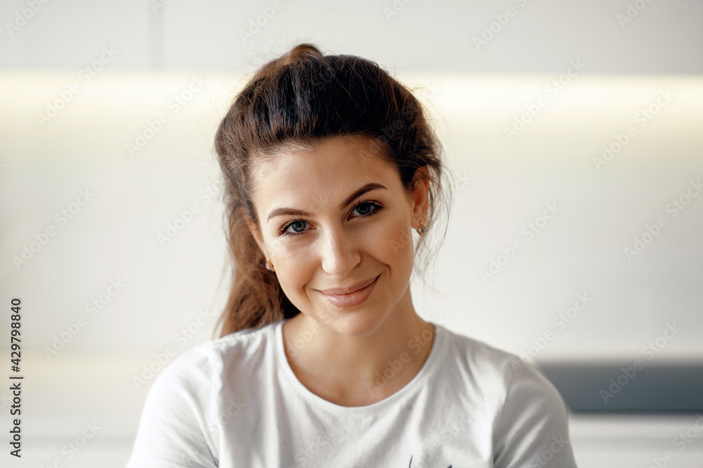 Portrait of a close woman of European appearance, looking at the camera. The beautiful brunette smiles. Portrait of a close woman of European appearance, looking at the camera. The beautiful brunette smiles.