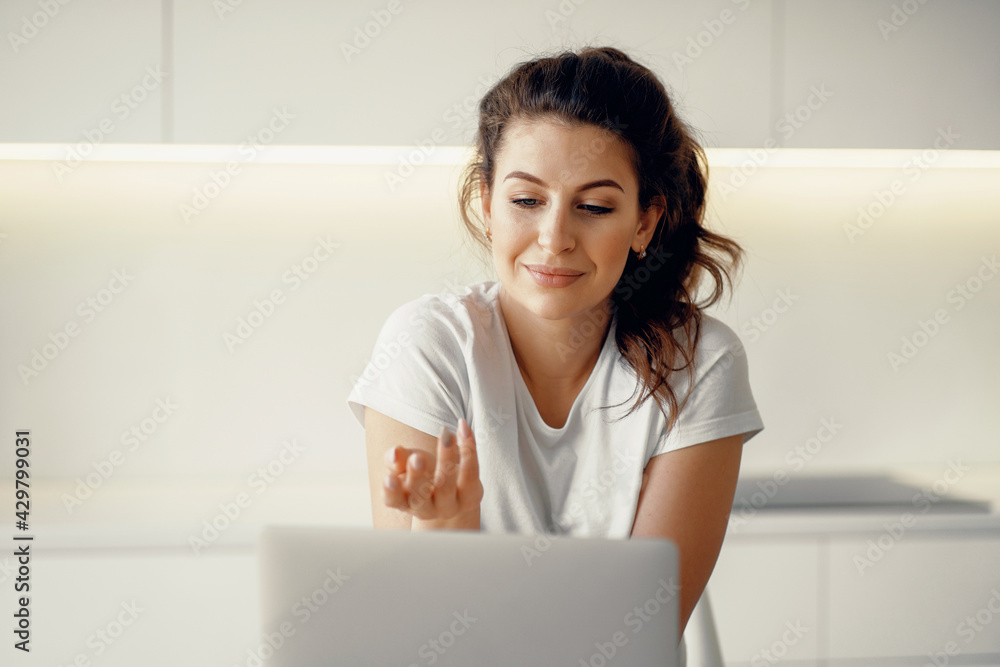 Communicates with friends via a social network. Young woman of European appearance online training on a laptop. A freelancer works by writing text on a computer. Communicates with friends via a social network. Young woman of European appearance online training on a laptop. A freelancer works by writing text on a computer.