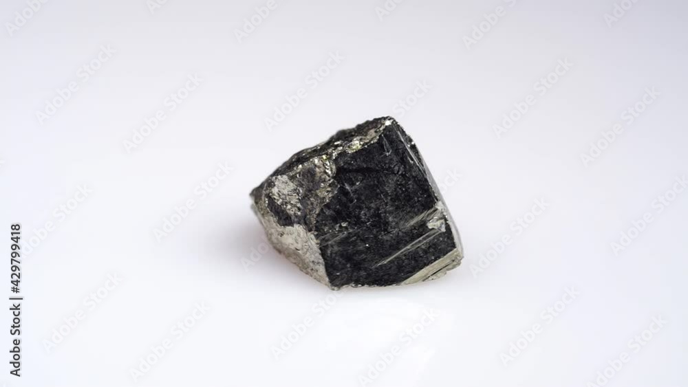 natural silver pyrite gemstone on the white turning table natural silver pyrite gemstone on the white turning table