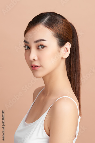 Beautiful young asian woman with clean fresh skin on beige background  Face care  Facial treatment  Cosmetology  beauty and spa  Asian women portrait