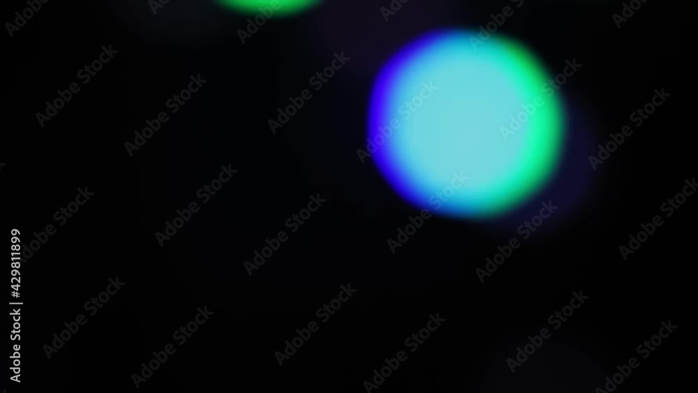 Bokeh blur on a black background with bright LED rays of colored light. Close-up Bokeh blur on a black background with bright LED rays of colored light. Close-up