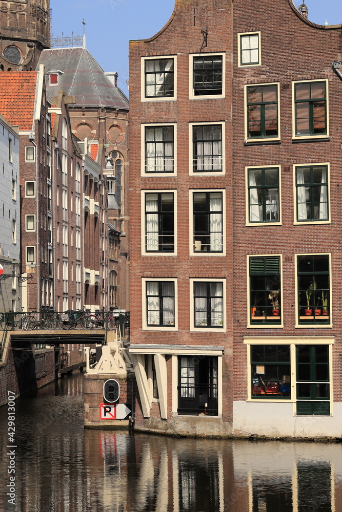 Amsterdam Traditional House Facades with Beam Bridge and Bicycles in the Red Light District