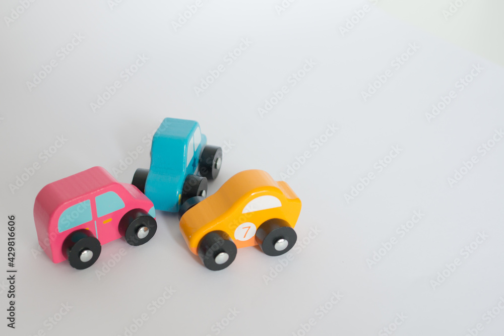 Three colorful toy cars involved in a car crash. With white background Three colorful toy cars involved in a car crash. With white background