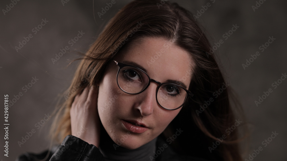 Young beautiful woman looks at the camera - photo shooting - studio photography Young beautiful woman looks at the camera - photo shooting - studio photography