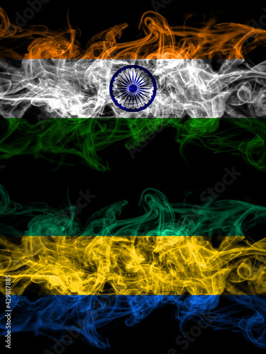 India, Indian vs Gabon, Gabonese, Gabonian smoky mystic flags placed side by side. Thick colored silky abstract smoke flags.