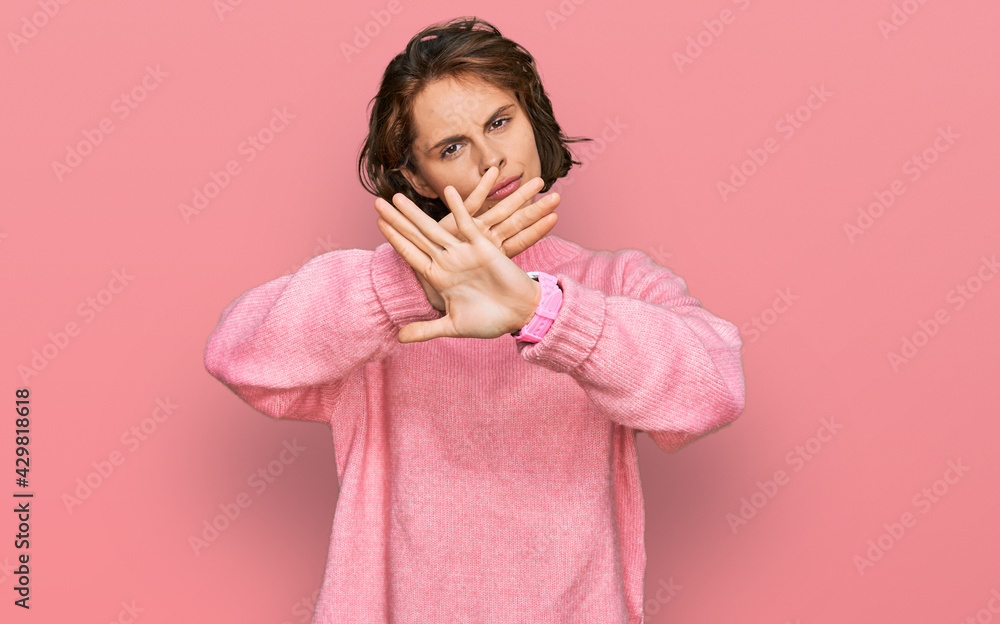 Young hispanic woman wearing casual clothes rejection expression crossing arms and palms doing negative sign, angry face