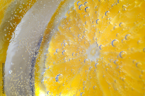 orange in sparkling water with bubbles. macro.