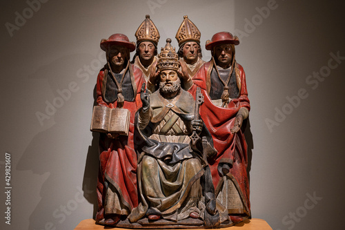 Carved wooden sculpture of Saint Peter with two cardinals and two bishops