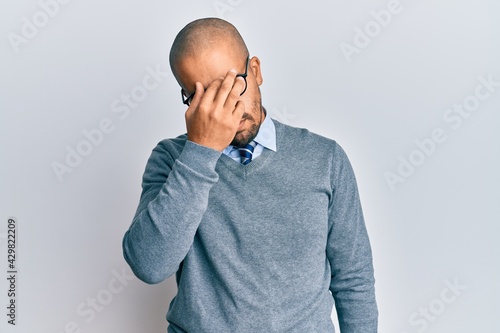 Hispanic adult man wearing glasses and business style tired rubbing nose and eyes feeling fatigue and headache. stress and frustration concept.