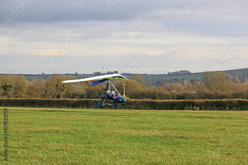 Valokuva Ultralight airplane landing on a grass strip