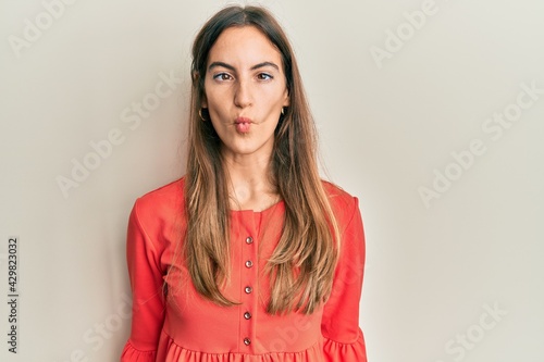 Young beautiful woman wearing casual clothes making fish face with lips, crazy and comical gesture. funny expression.