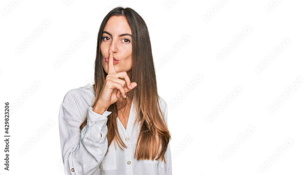 Young beautiful woman wearing casual clothes asking to be quiet with finger on lips. silence and secret concept. Young beautiful woman wearing casual clothes asking to be quiet with finger on lips. silence and secret concept.