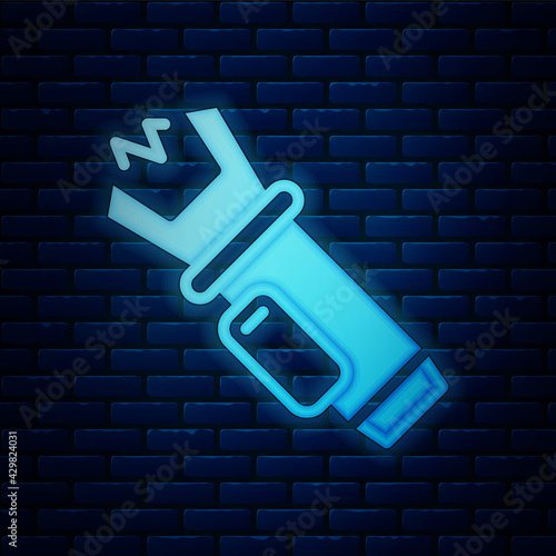 Glowing neon Police electric shocker icon isolated on brick wall background. Shocker for protection. Taser is an electric weapon. Vector