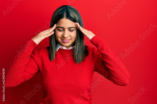 Young latin woman wearing casual clothes with hand on head for pain in head because stress. suffering migraine. © Krakenimages.com