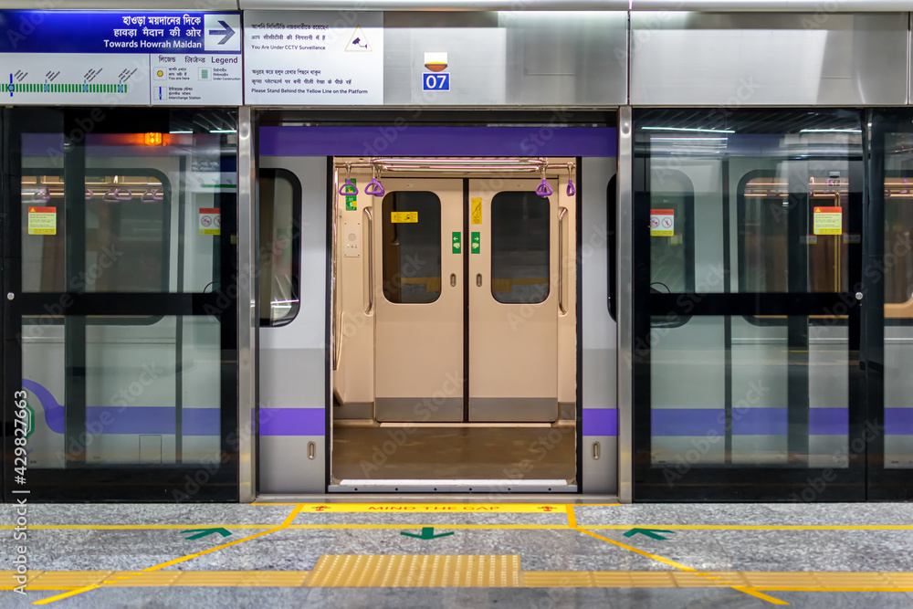 Metro train stopping at a station and open the door to wait for passengers to enter during the rush hour at metro station of Kolkata East West Metro system Kolkata. - obrazy, fototapety, plakaty 