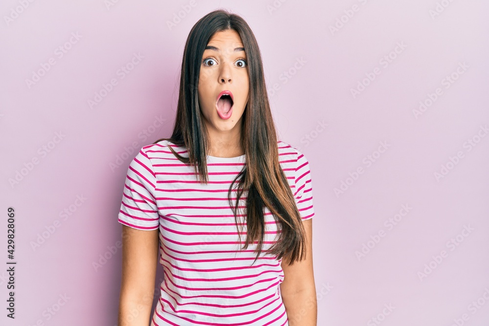 Young brunette woman wearing casual clothes over pink background afraid and shocked with surprise and amazed expression, fear and excited face. Young brunette woman wearing casual clothes over pink background afraid and shocked with surprise and amazed expression, fear and excited face.
