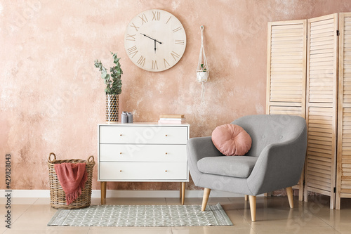 Foto Interior of stylish living room with modern chest of drawers
