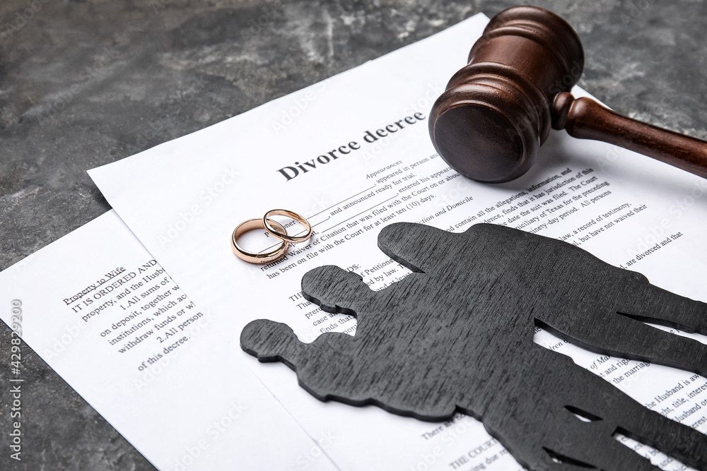 Figures of family with judge's gavel and divorce decree, closeup