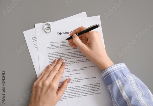 Woman signing decree of div...