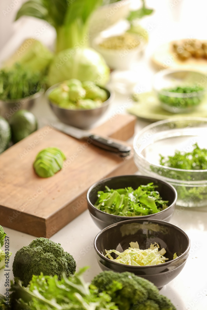 Bowls with fresh vegetables on light background Bowls with fresh vegetables on light background