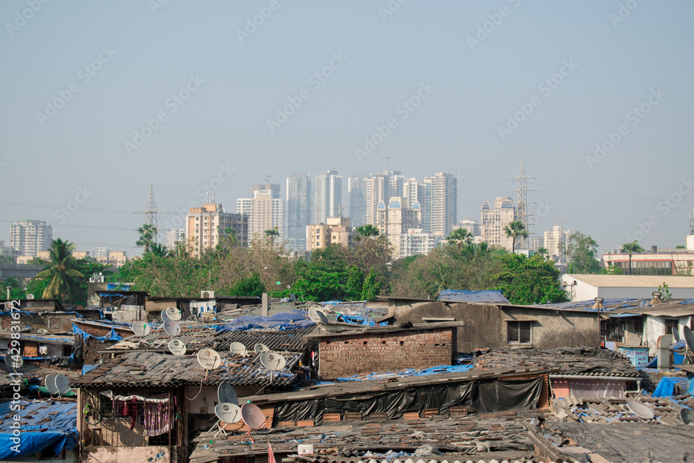 Rural to urban development of mumbai ,Maharashtra with trees and skyscrapers in background Rural to urban development of mumbai ,Maharashtra with trees and skyscrapers in background