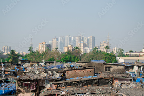 Rural to urban development of mumbai ,Maharashtra with trees and skyscrapers in background © deep
