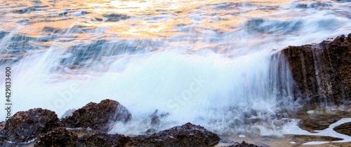 Blurred abstract natural background of sea water with waves and foam. Motion blur. Nature. Banner. 