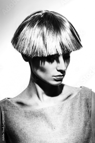 Elegant beautiful blonde woman posing in studio, wearing fashionable dress
