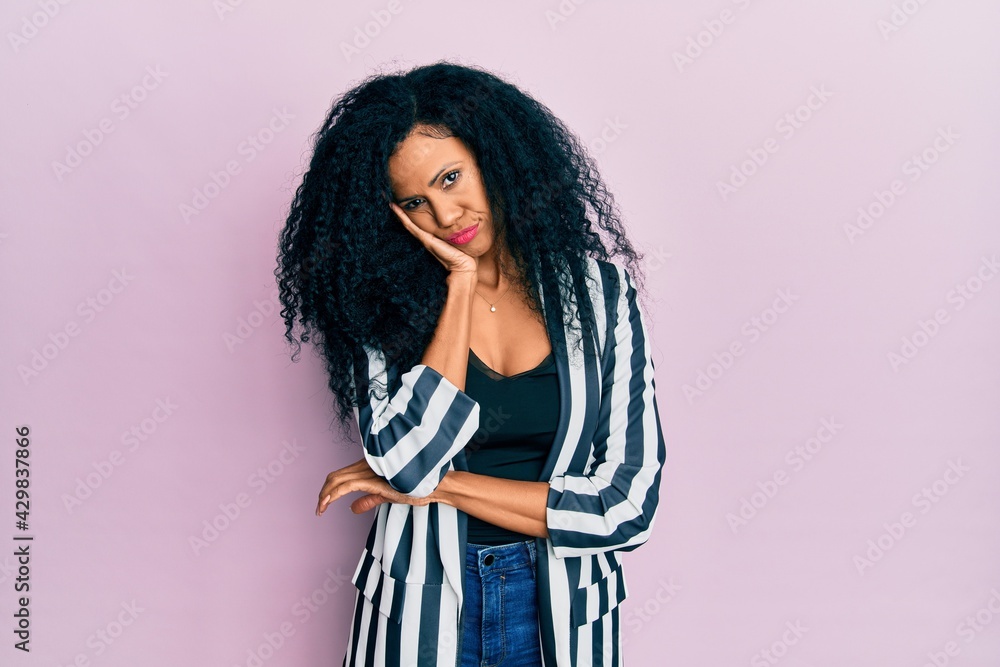 Middle age african american woman wearing casual clothes thinking looking tired and bored with depression problems with crossed arms. Middle age african american woman wearing casual clothes thinking looking tired and bored with depression problems with crossed arms.