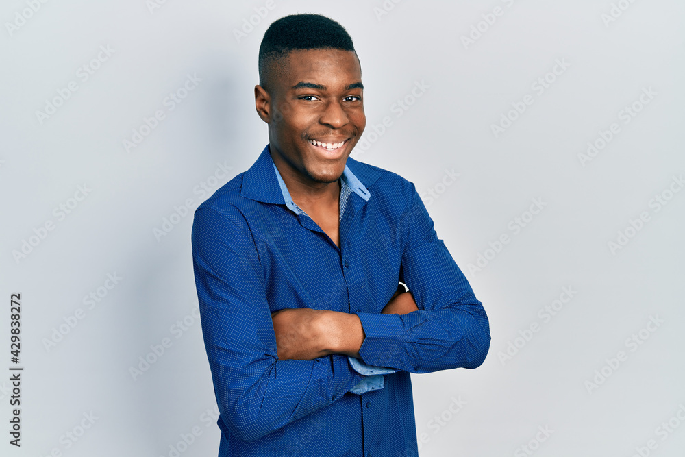 Young african american man with arms crossed gesture smiling and laughing hard out loud because funny crazy joke. Young african american man with arms crossed gesture smiling and laughing hard out loud because funny crazy joke.