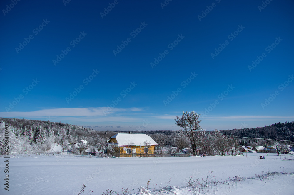 Panorama of a winter village covered with snow