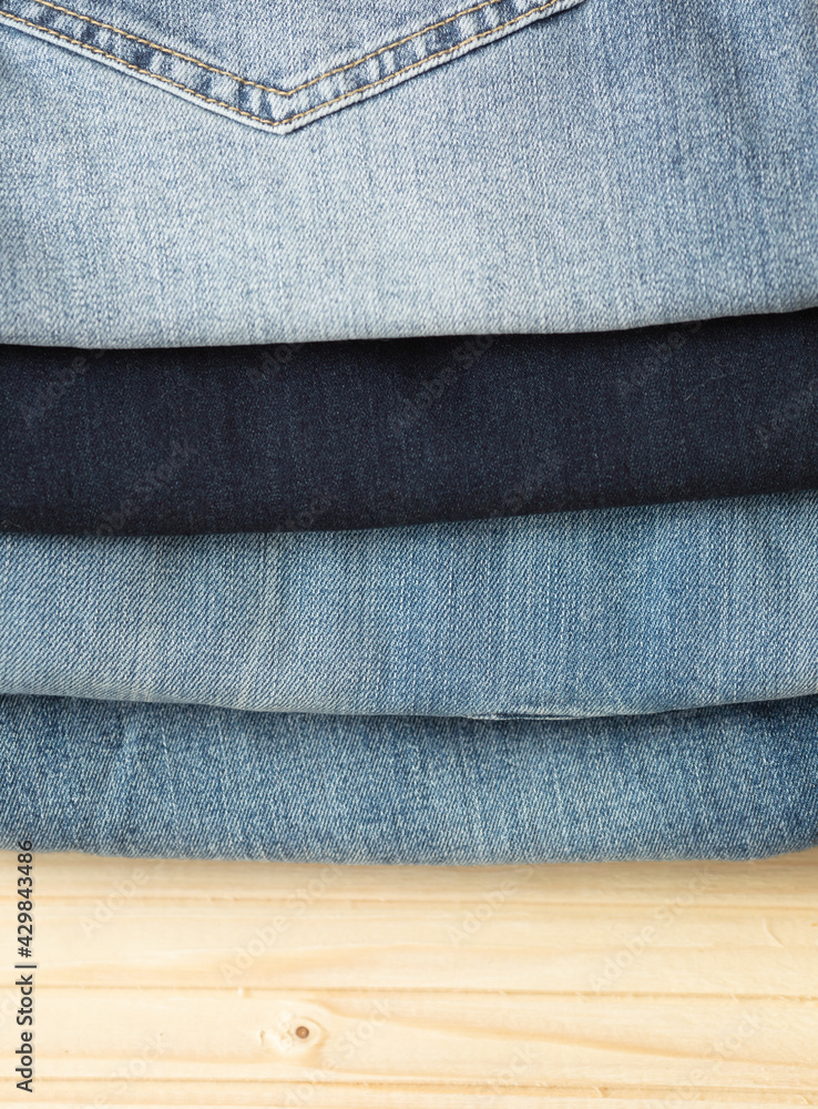 Blue jeans on a wooden background, texture of denim.