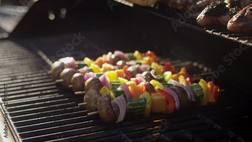 Slow motion shot of gorgeous skewered vegetables on the grill